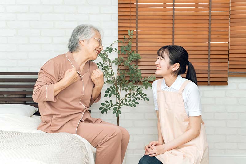 介護士と話す高齢女性